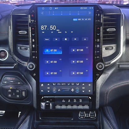 Car interior with a large touchscreen display showing vehicle information.